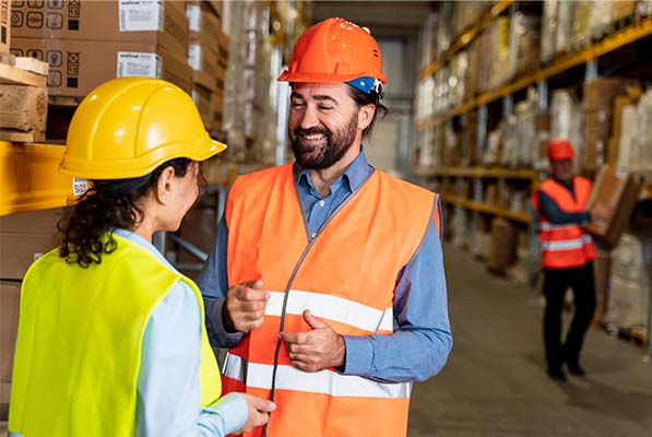 man and woman handling air freight cargo at a warehouse